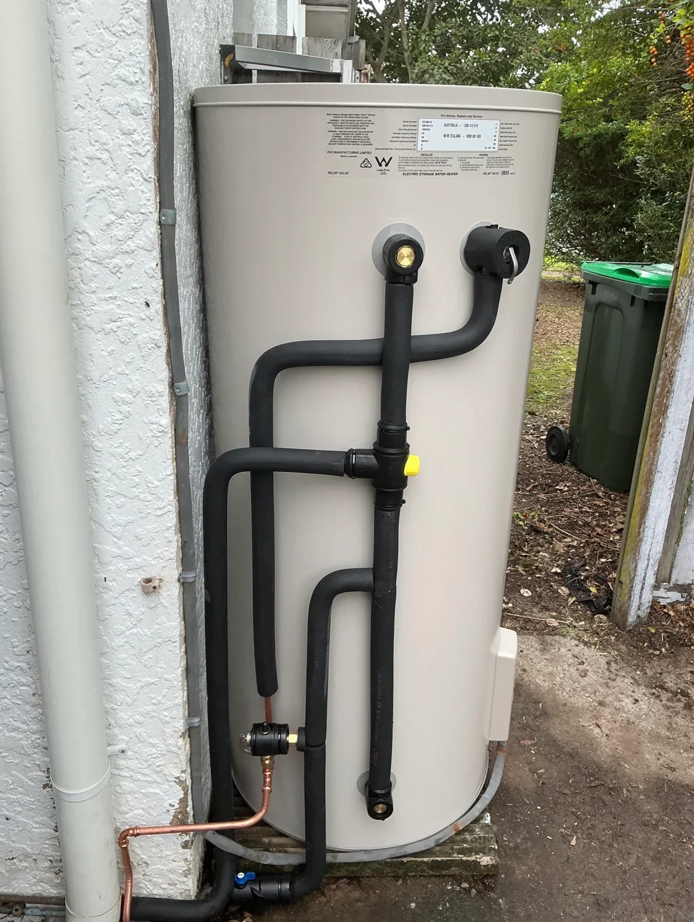 Storage hot water unit with insulated pipework