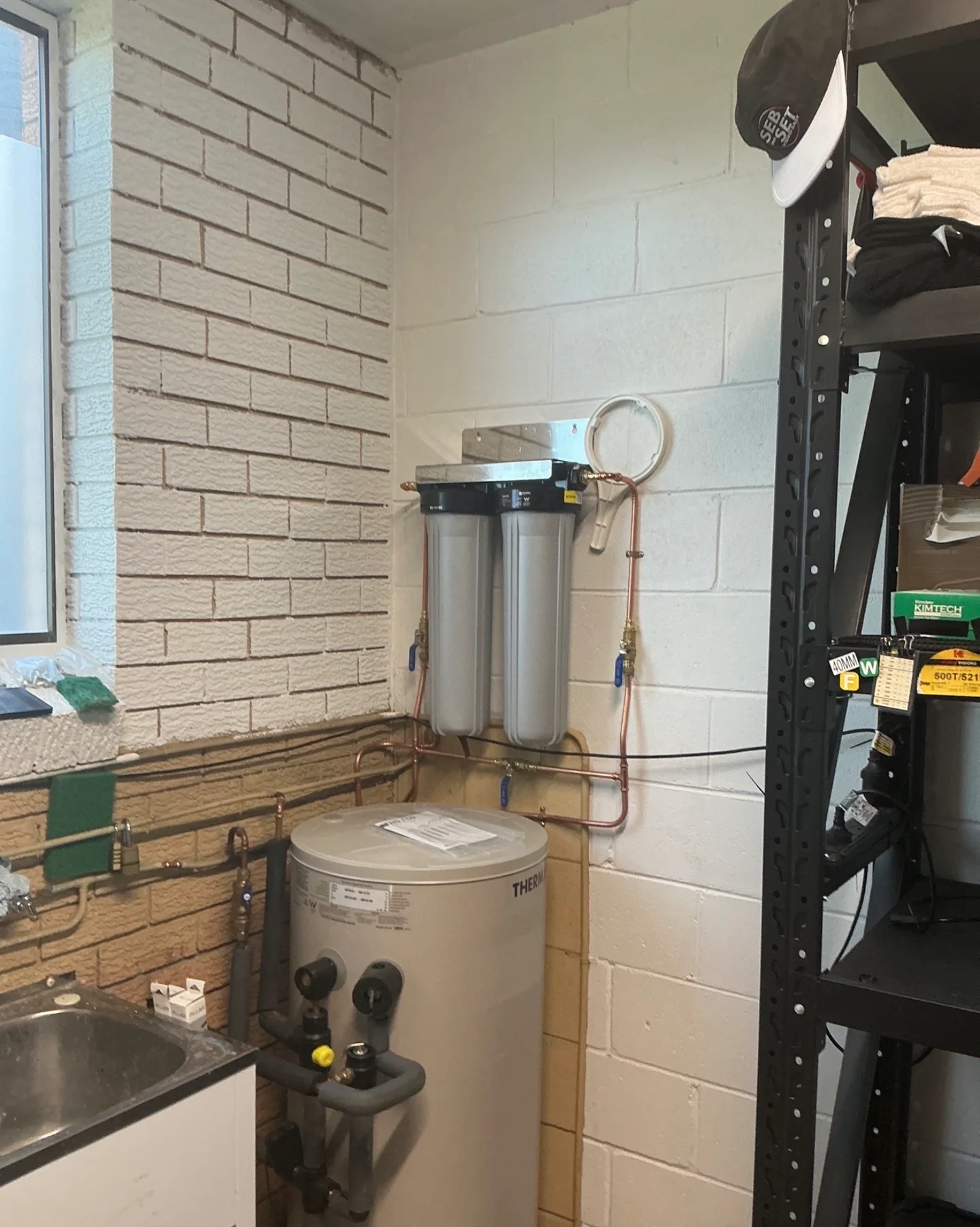 Twin whole house filtration housings connected to copper pipework